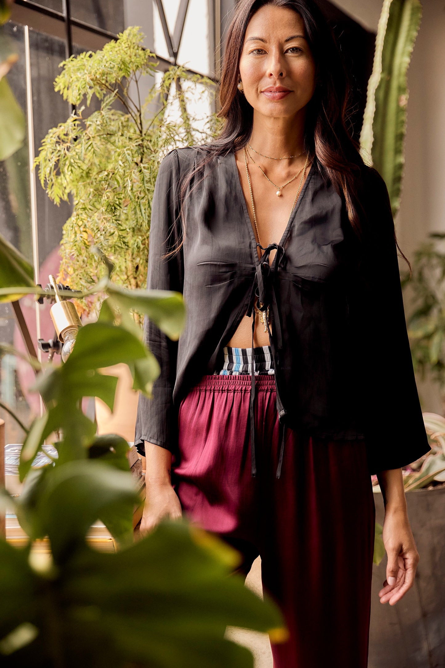 The Solune Muse Top Black — black satin loungewear top designed for leisure, travel, and relaxed styling